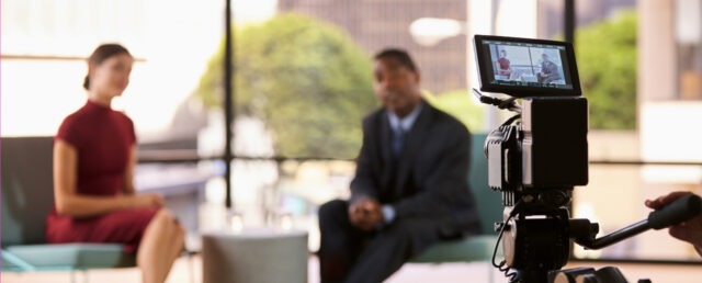 camera filming two people doing a interview